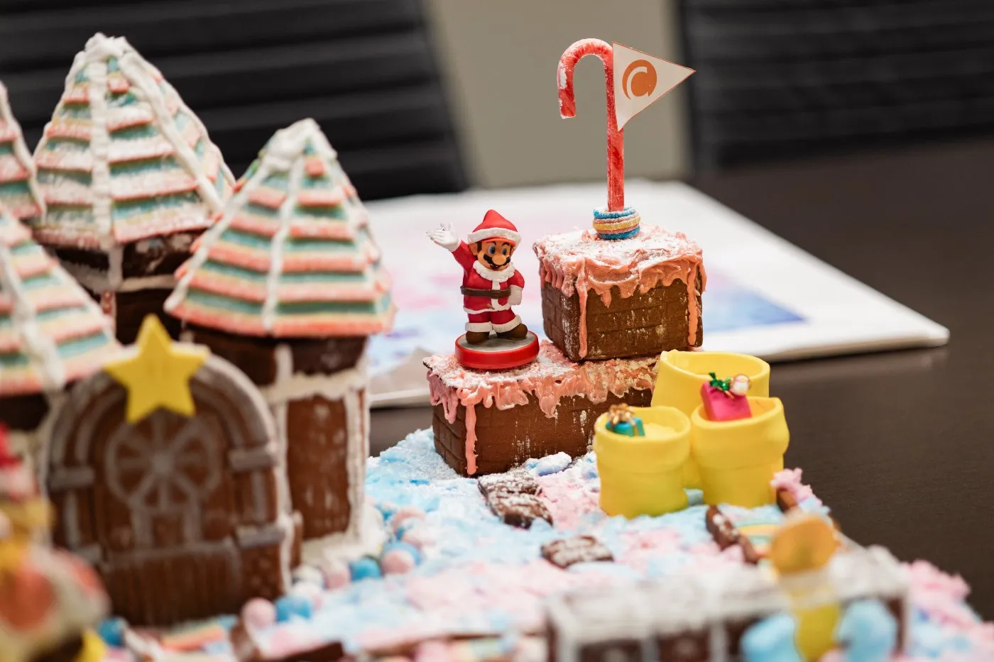Close-up of a gingerbread castle entry with striped turrets and a gold star, displayed at the reception